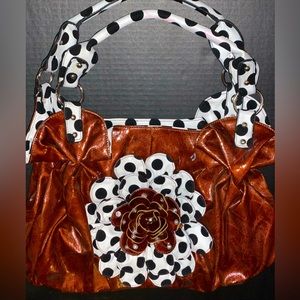 Gorgeous brown purse with polka dots and a huge flower embellishment.
